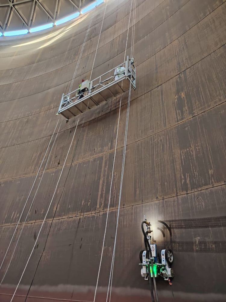 Inside a terminal tank — robot below, cradle above